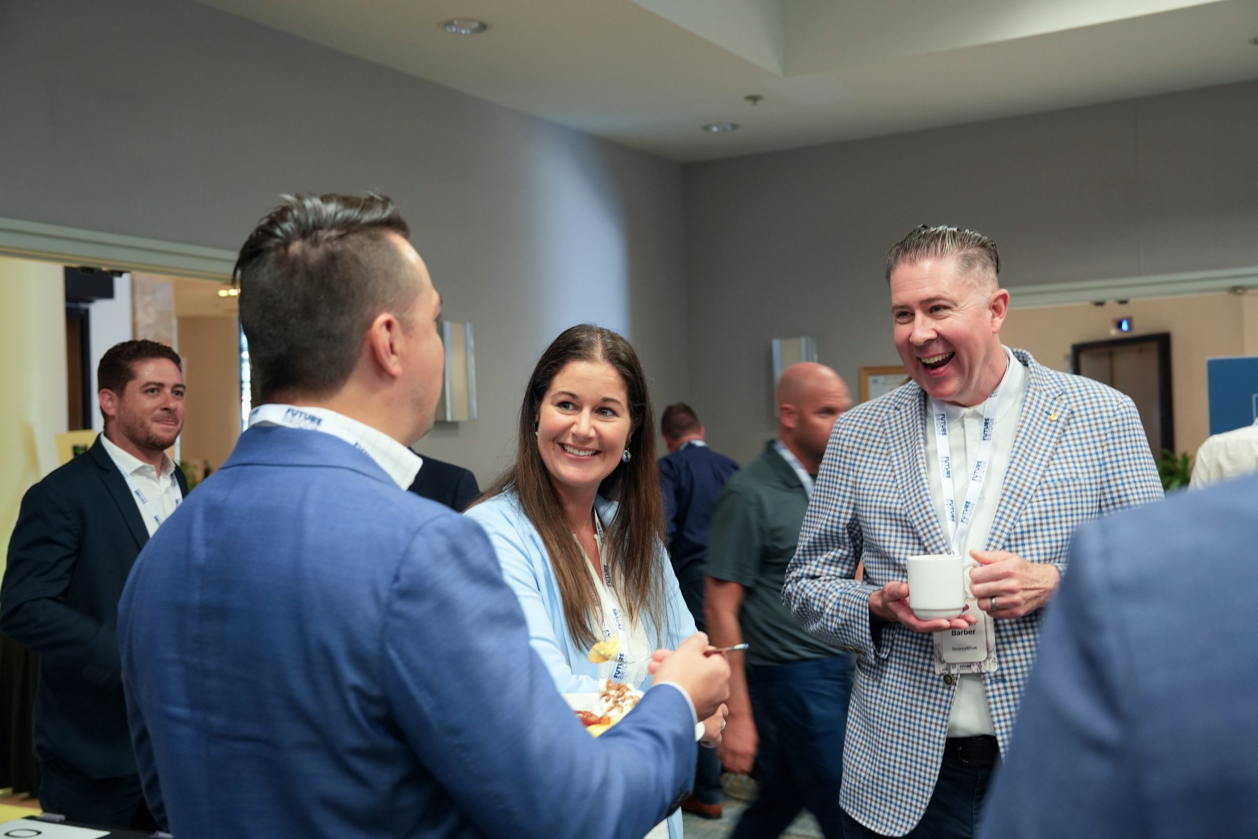 Delegates in conversation during a networking break at a Future Bridge summit